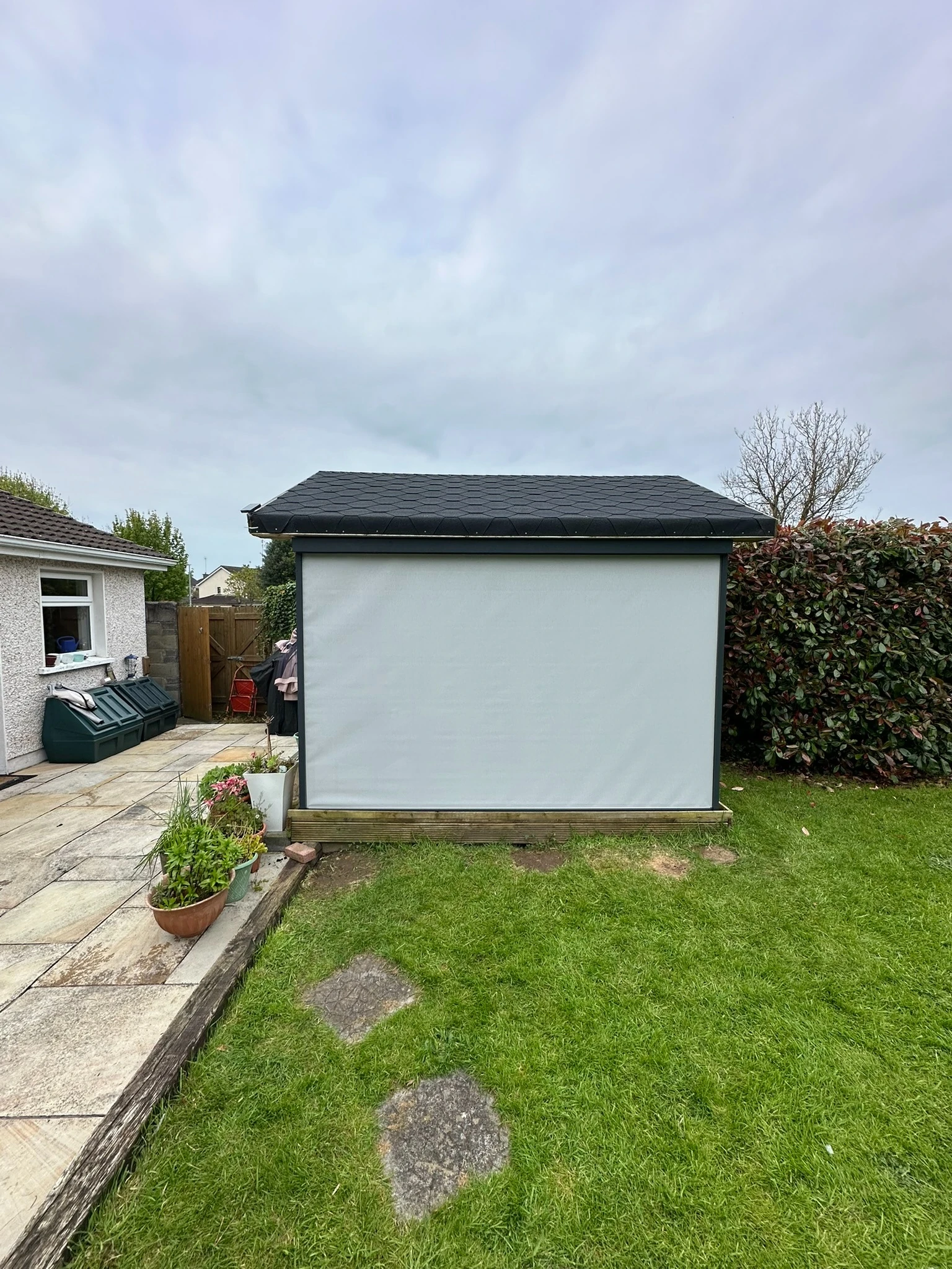 Grey ZIP screen fitted to the side of a timber garden room in Ireland